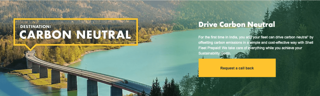Shell advertisement reading "Destination: Carbon Neutral" with a scenic view in the background, promoting its Drive Carbon Neutral program for Indian customers.
